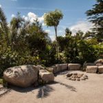 How to use large boulders to create a natural garden seating around fire pit