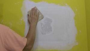 photo sanding a drywall patch