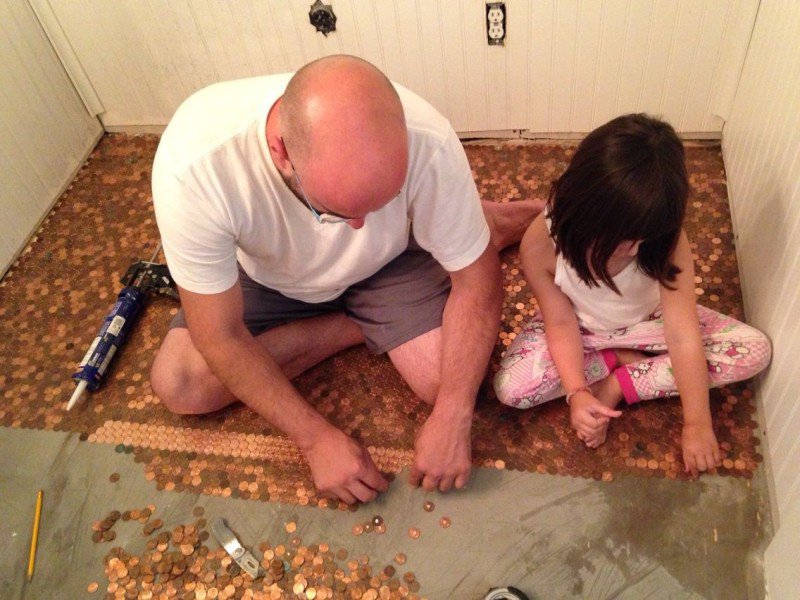 отец и дочь на полу из монет