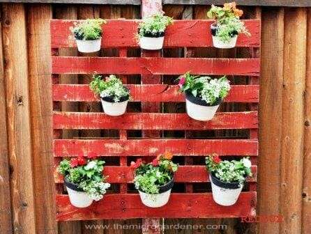 Pots hanging on a wooden pallet 